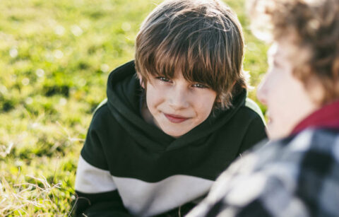smiley-boy-with-his-friend-grass-outdoors